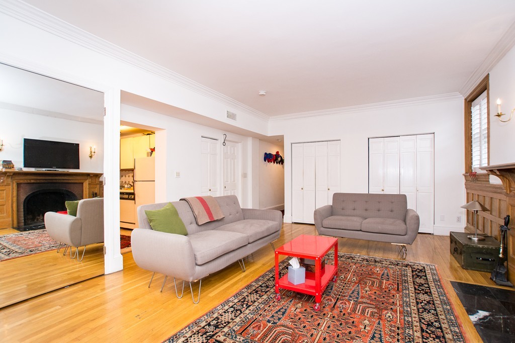 280 Commonwealth Avenue, Unit G9 Boston, MA 02116 - Photo 7 of 18 a living room with furniture and a flat screen tv