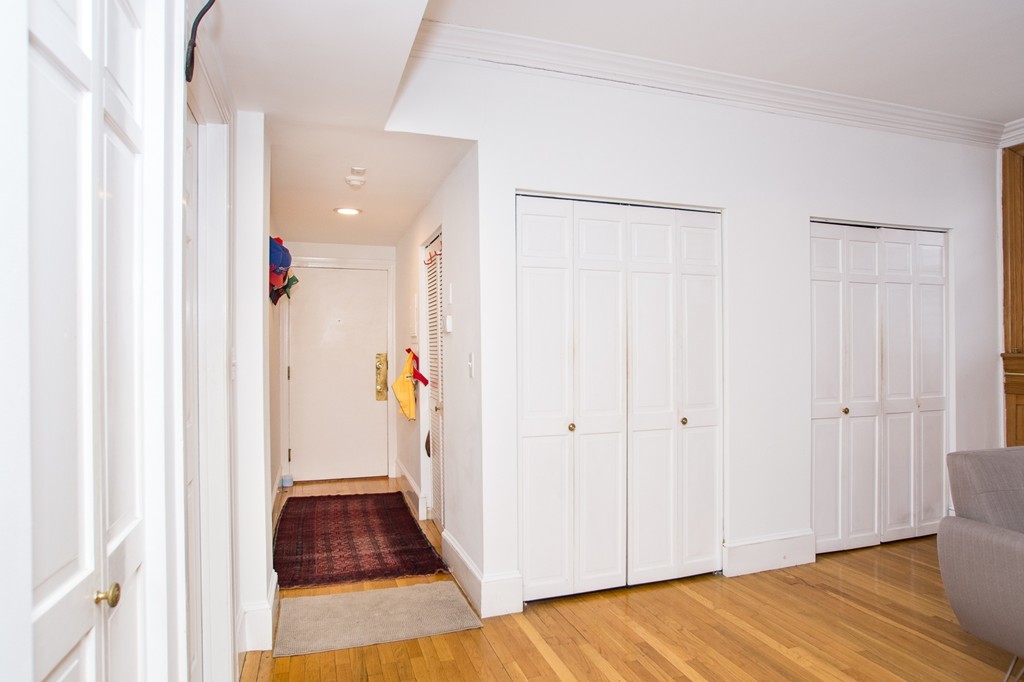 280 Commonwealth Avenue, Unit G9 Boston, MA 02116 - Photo 8 of 18 a view of a hallway with wooden floor and staircase