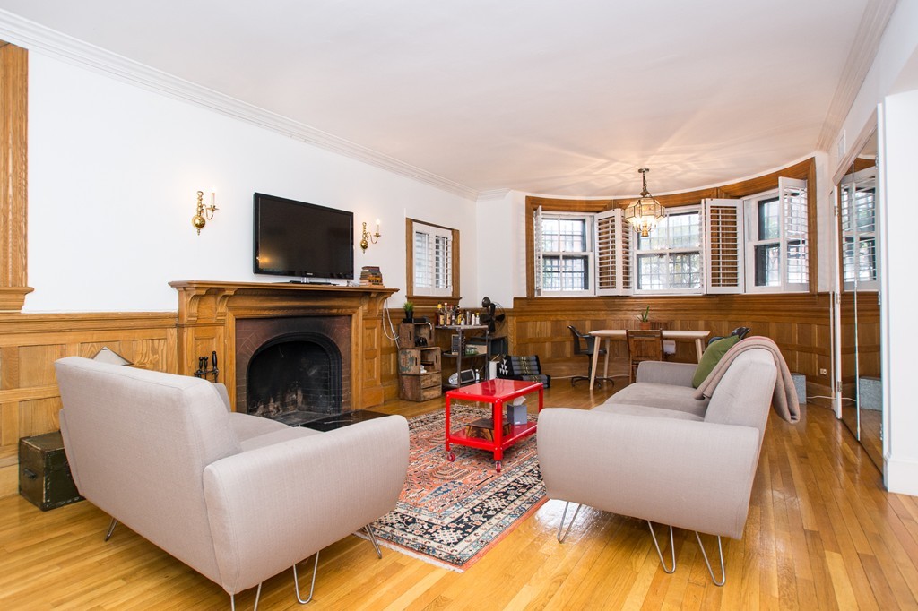 280 Commonwealth Avenue, Unit G9 Boston, MA 02116 - Photo 9 of 18 a living room with furniture and a fireplace