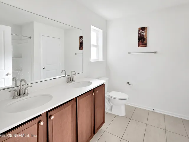 a bathroom with a double vanity sink and a mirror