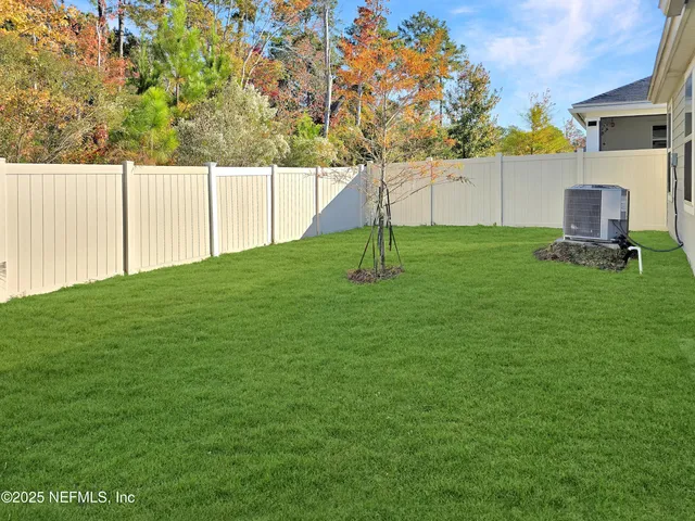 a backyard of a house with table and chairs