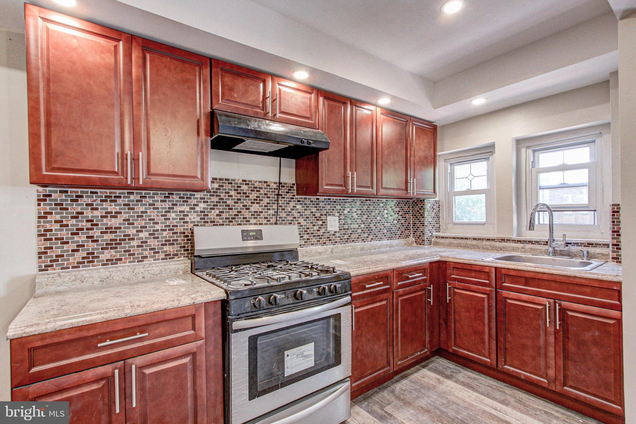 524 Glendale Road Upper Darby, PA 19082 - Photo 22 of 51 a kitchen with stainless steel appliances granite countertop a stove a sink dishwasher and microwave
