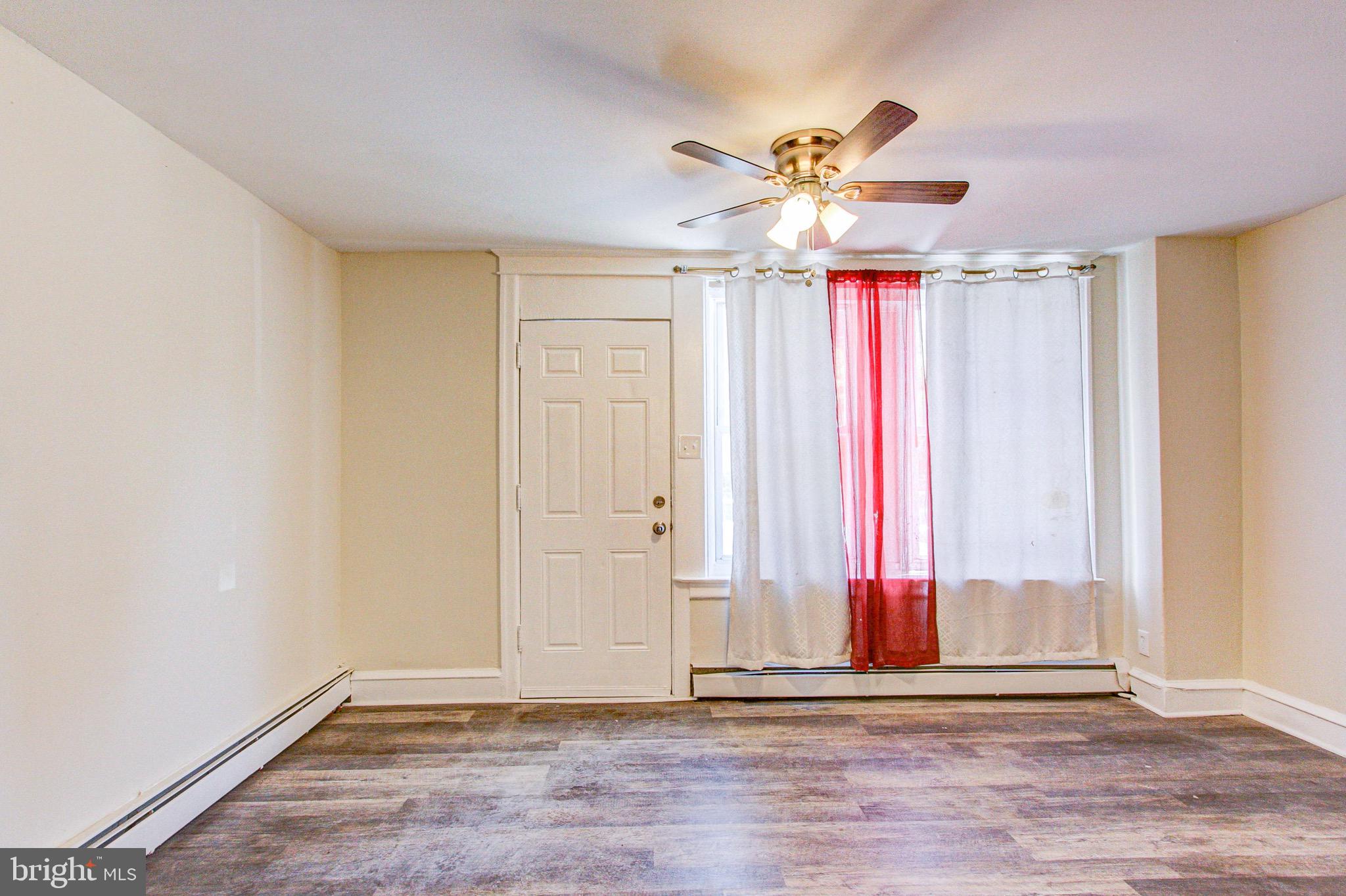 524 Glendale Road Upper Darby, PA 19082 - Photo 7 of 51 a view of a livingroom with a ceiling fan and window