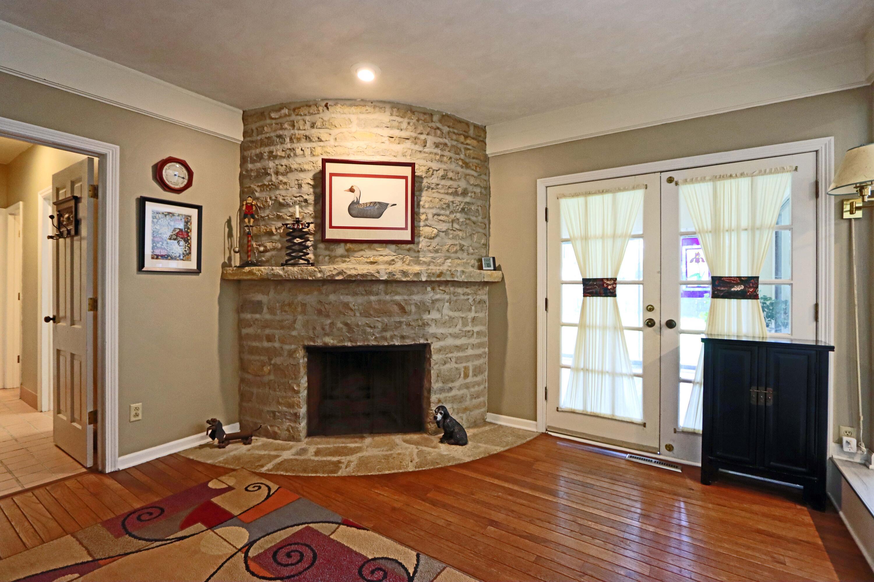 3969 Newhall Road Upper Arlington, OH 43220 - Photo 27 of 82 curve stone gas fireplace in the family room with hardwood flooring