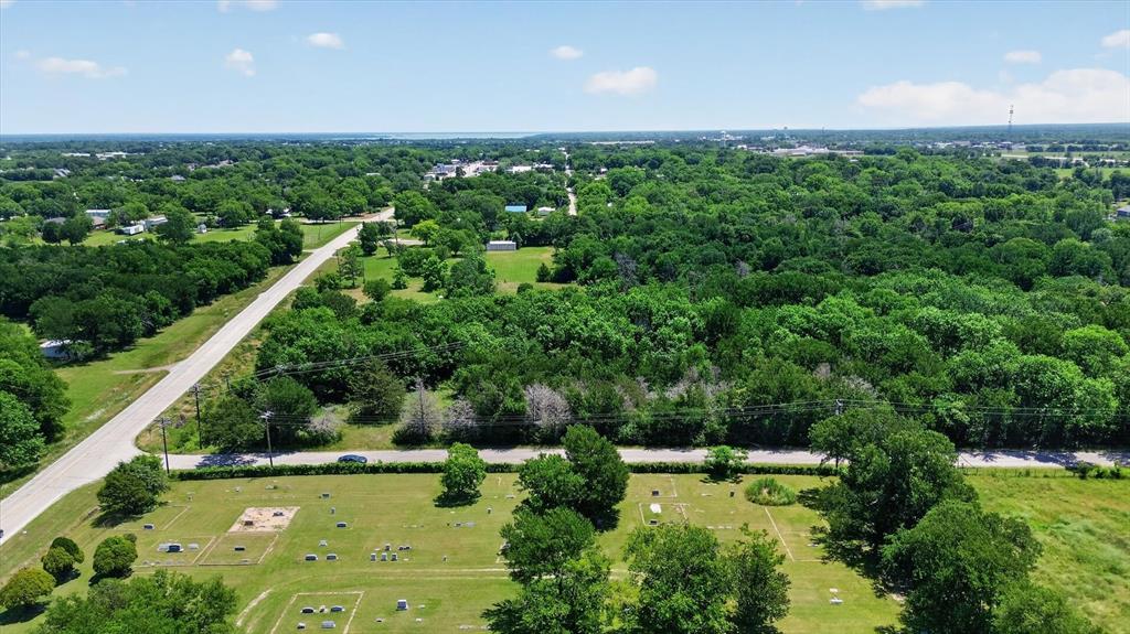 613 Main Street Quinlan, TX 75474 - Photo 16 of 16 Expansive tree canopy with a distant body of water visible on the horizon