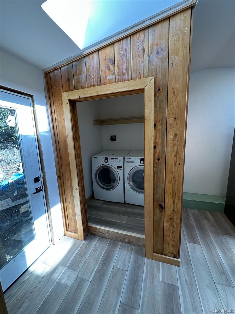 397 Glendale Gulch Road Boulder, CO 80302 - Photo 15 of 17 a view of a hallway with wooden floor and staircase
