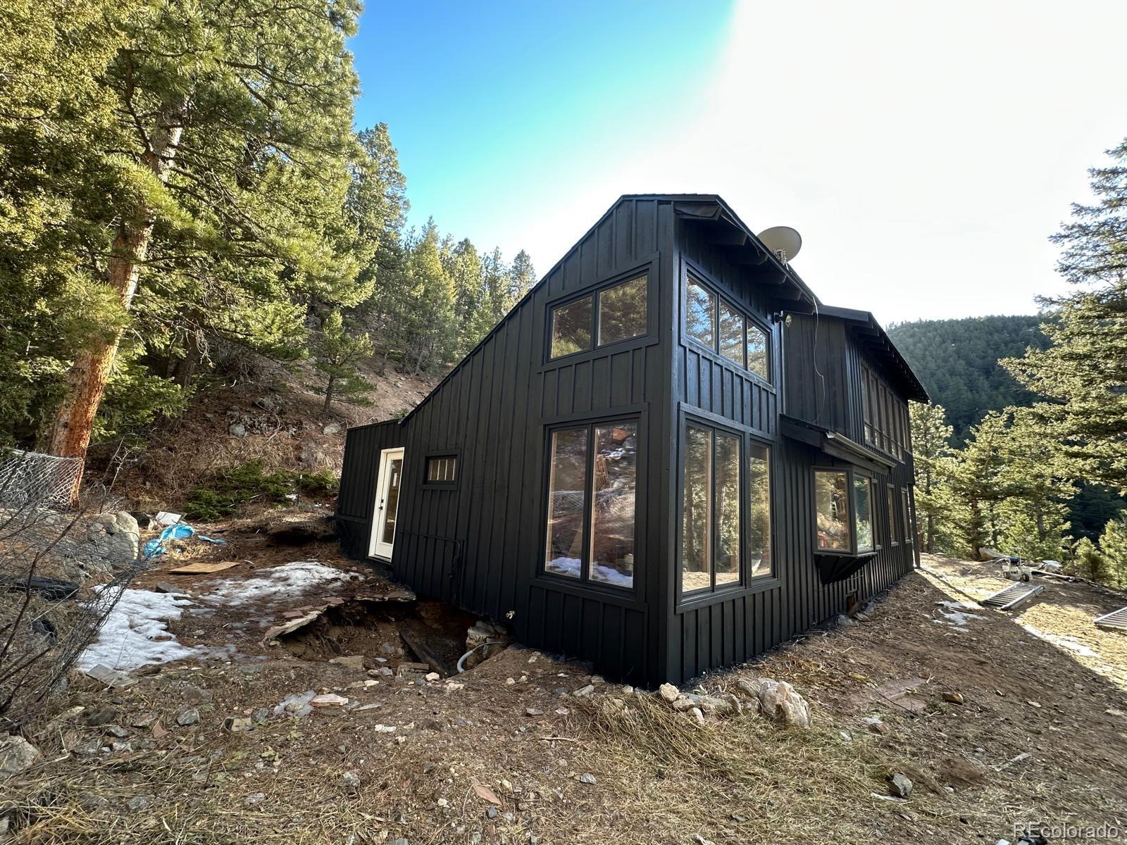 397 Glendale Gulch Road Boulder, CO 80302 - Photo 7 of 17 a view of a house with a yard