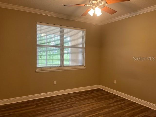 200 Riverview Bend South, Unit 911 Palm Coast, FL 32137 - Photo 11 of 23 a view of an empty room with wooden floor and a window