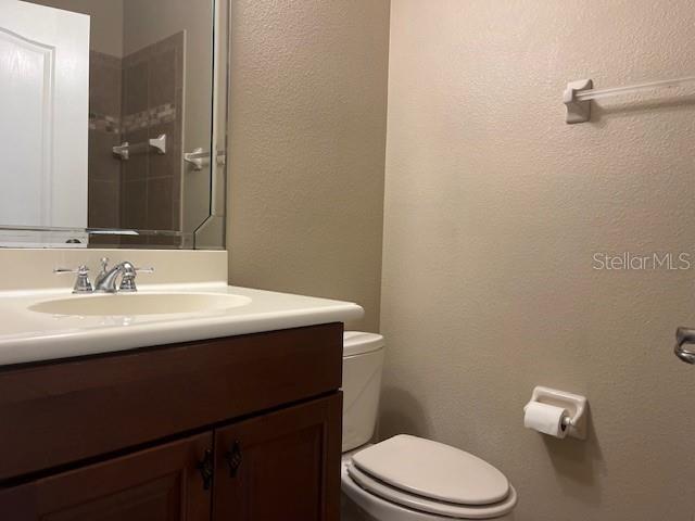200 Riverview Bend South, Unit 911 Palm Coast, FL 32137 - Photo 18 of 23 a bathroom with a sink a toilet and a mirror