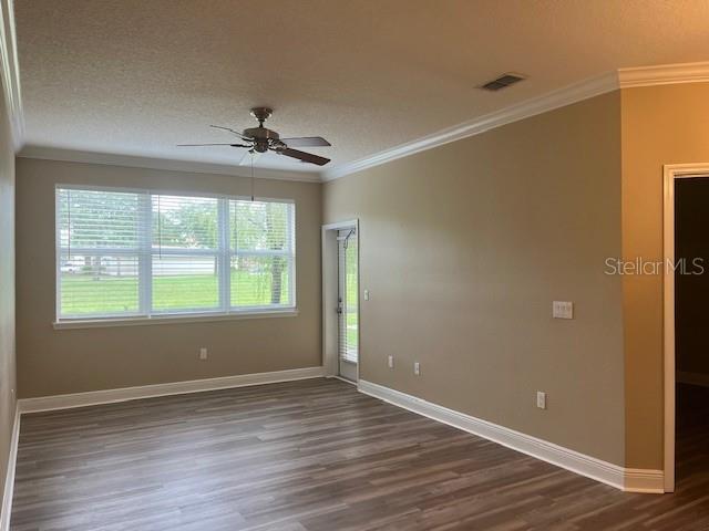 200 Riverview Bend South, Unit 911 Palm Coast, FL 32137 - Photo 6 of 23 an empty room with wooden floor and windows