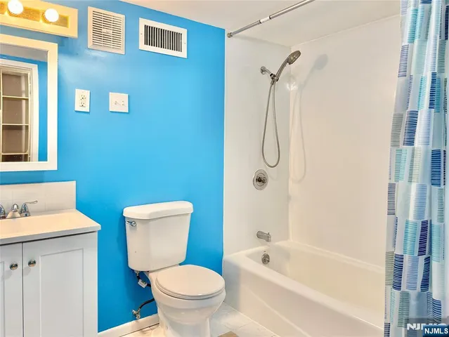 a bathroom with a toilet sink and shower