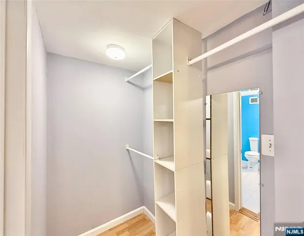 a bathroom with a mirror and a shower