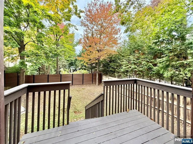 a balcony with wooden floor and fence
