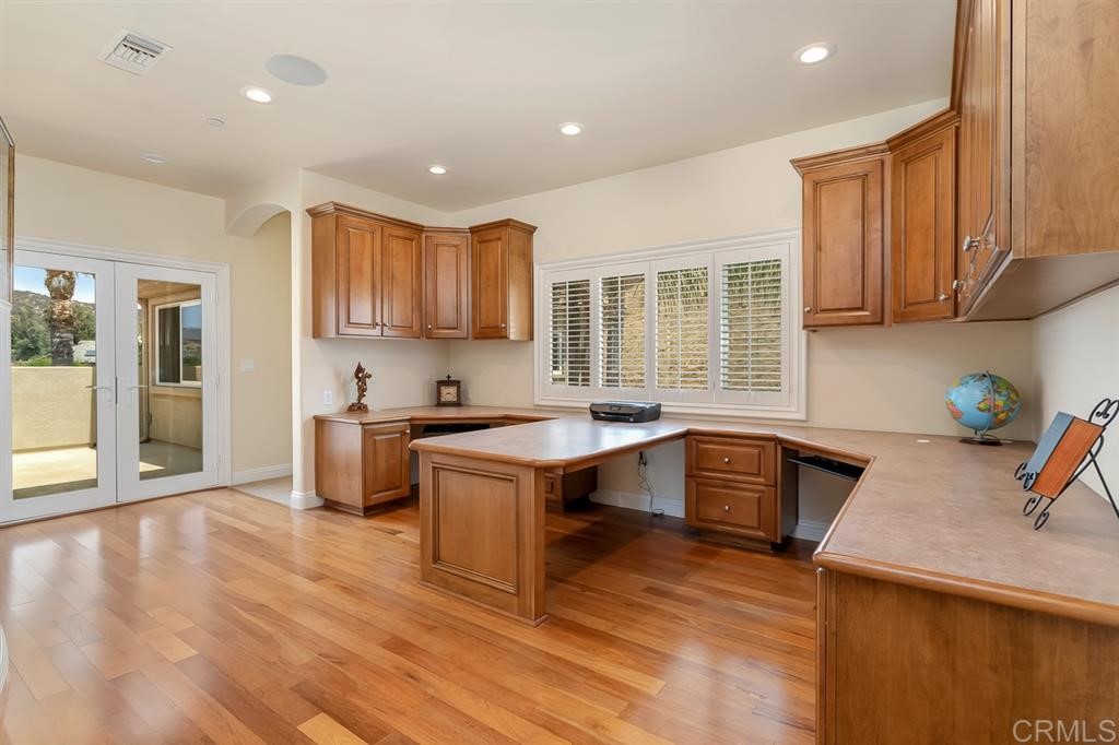 13410 Farraday Ridge Road Jamul, CA 91935 - Photo 13 of 23 a kitchen with granite countertop a sink cabinets and wooden floor