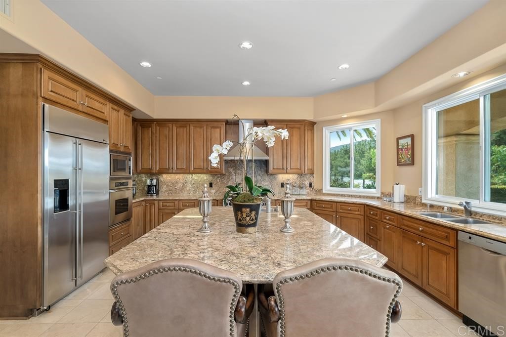 13410 Farraday Ridge Road Jamul, CA 91935 - Photo 5 of 23 a kitchen with stainless steel appliances granite countertop a refrigerator a sink a stove and island