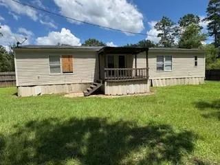 a front view of house with yard and outdoor seating
