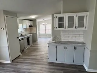 a kitchen with stainless steel appliances granite countertop a stove and cabinets