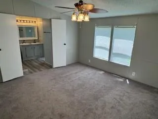 an empty room with a bathroom and a sink