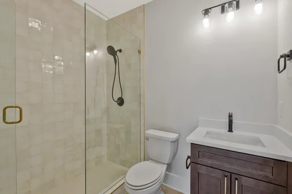 a bathroom with a sink toilet and shower