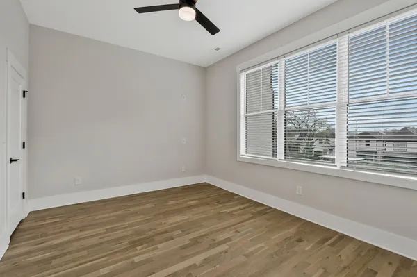 a view of a room with wooden floor and windows