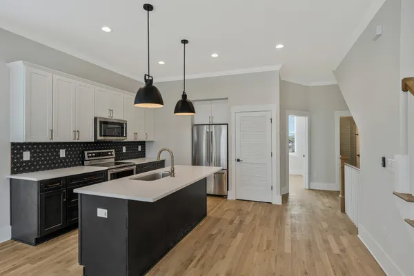 a kitchen with stainless steel appliances granite countertop a stove and a refrigerator