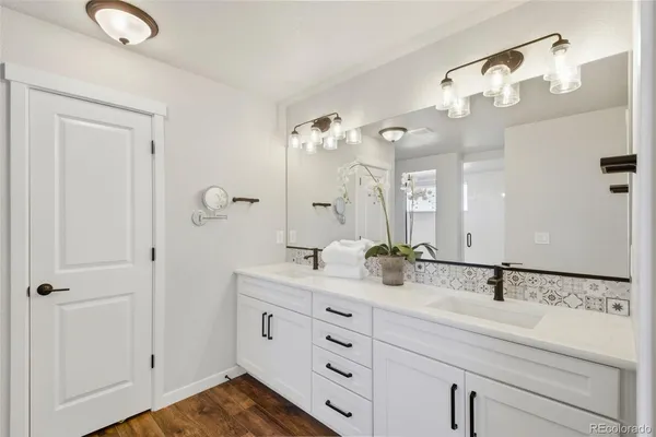 a bathroom with a double vanity sink and a mirror