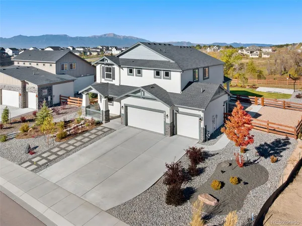an aerial view of a house with a yard