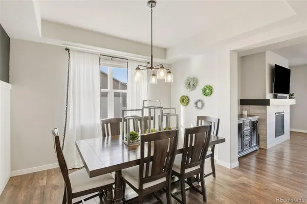 a view of a dining room with furniture window and wooden floor