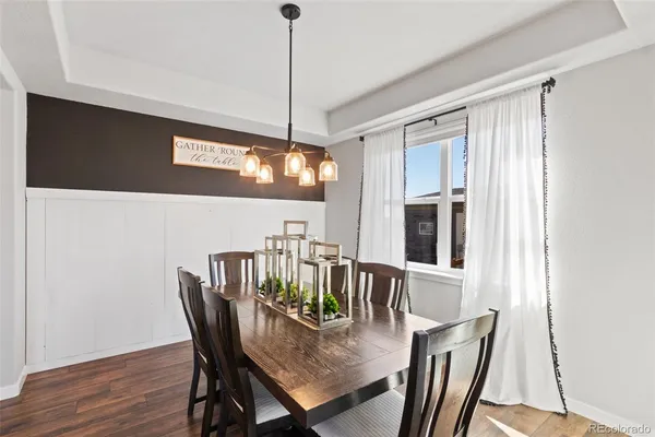a view of a dining room with furniture window and wooden floor