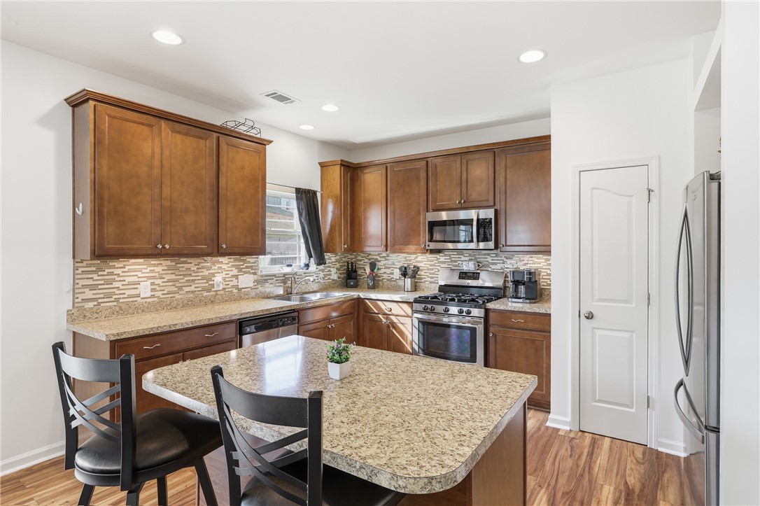347 Riverdale Road Simpsonville, SC 29680 - Photo 7 of 30 This functional kitchen features rich wood cabinetry, stainless steel appliances, and a convenient island for everyday living.