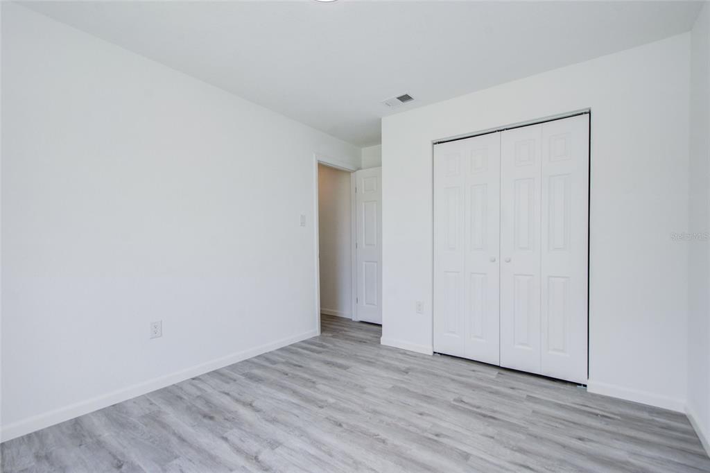 3540 65th Ave Circle East Sarasota, FL 34243 - Photo 12 of 69 a view of an empty room with wooden floor