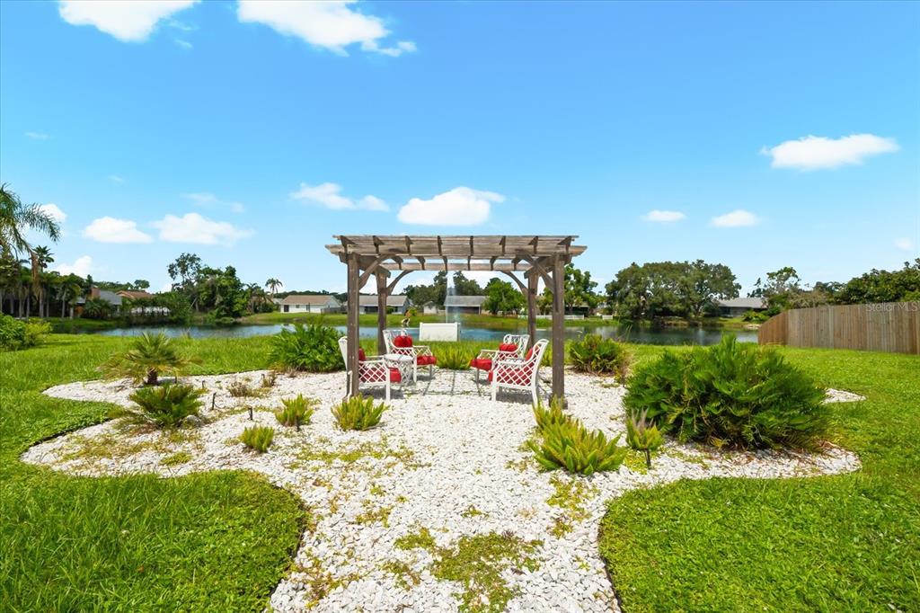 3540 65th Ave Circle East Sarasota, FL 34243 - Photo 21 of 69 a view of a lake with a big yard
