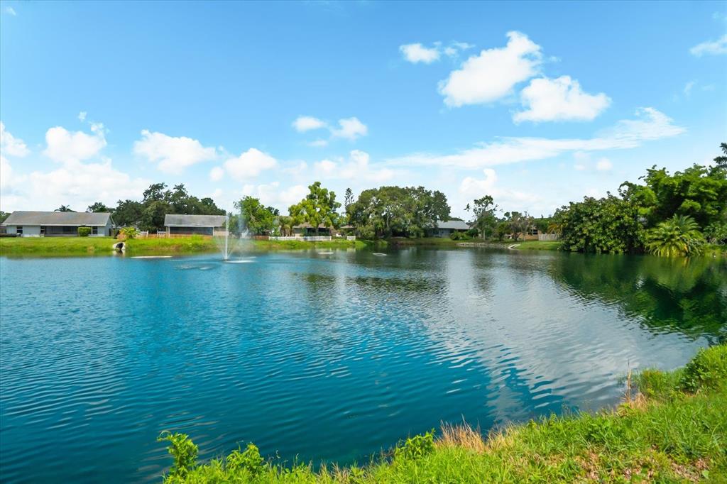 3540 65th Ave Circle East Sarasota, FL 34243 - Photo 22 of 69 a view of a lake with houses in the background
