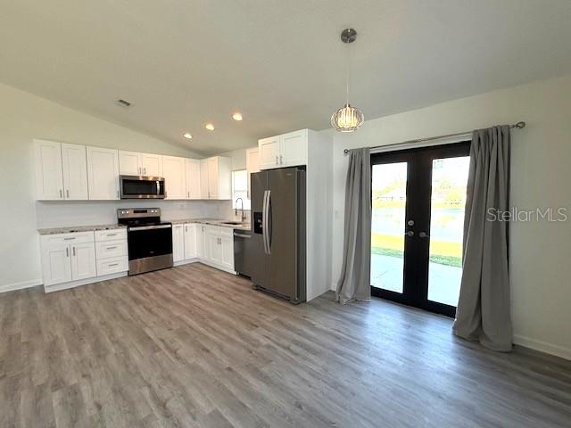 3540 65th Ave Circle East Sarasota, FL 34243 - Photo 4 of 69 a kitchen with a refrigerator and a stove top oven
