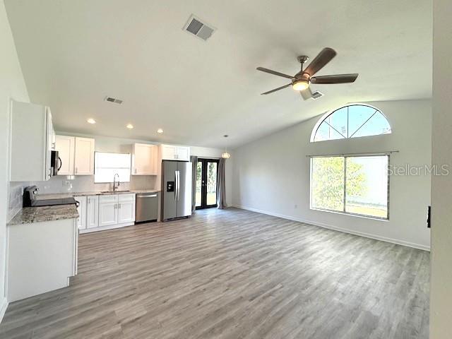 3540 65th Ave Circle East Sarasota, FL 34243 - Photo 5 of 69 a view of a kitchen with a sink wooden floor and a window