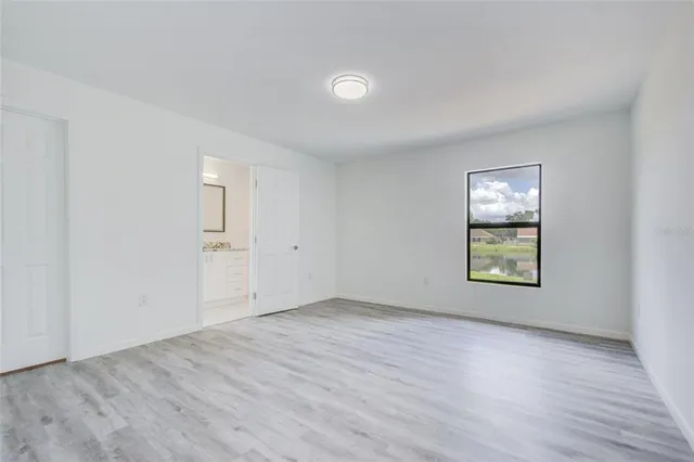 an empty room with windows and closet