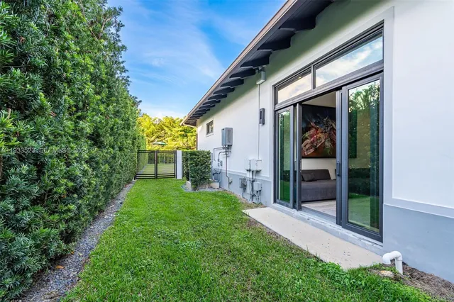 a living room with furniture and large windows