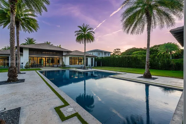 a view of a patio with a dining table and chairs with a small yard