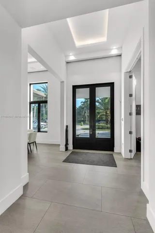 a living room with furniture large window and a flat screen tv