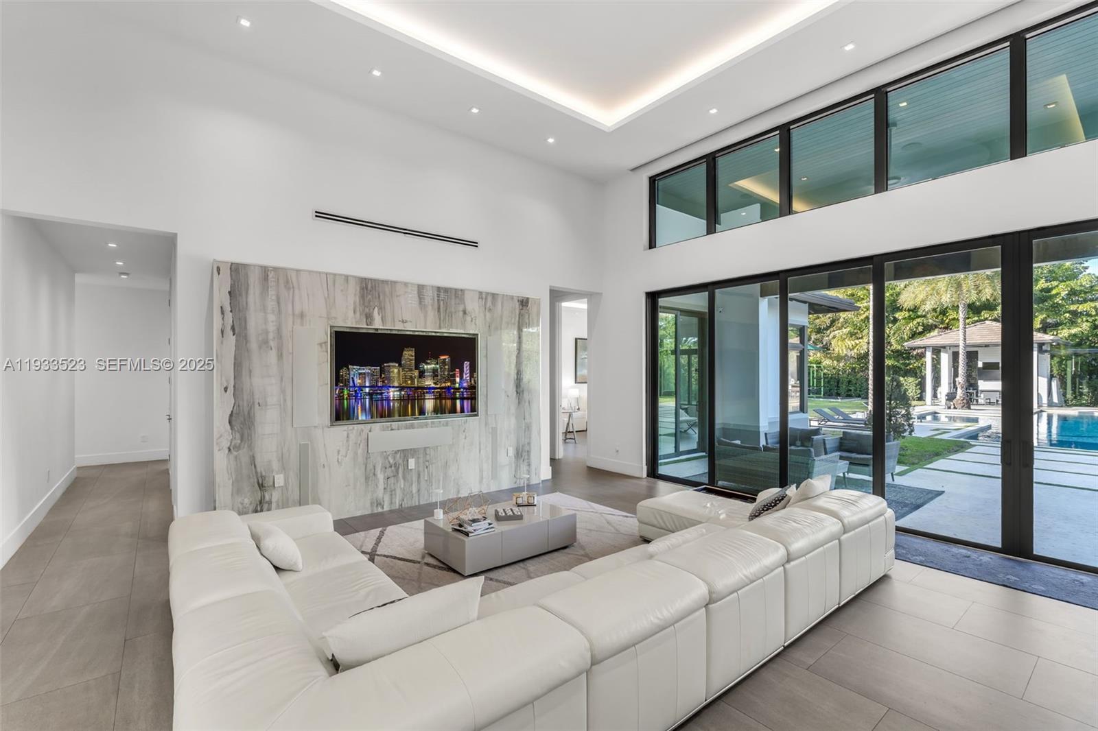 8271 Southwest 67th Street Miami, FL 33143 - Photo 30 of 88 a living room with furniture and a flat screen tv