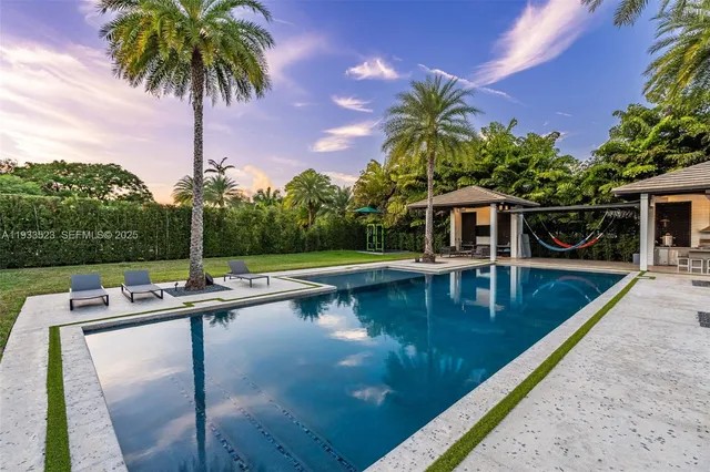 a view of a house with swimming pool and sitting area