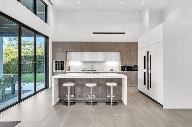 a view of a living room and a floor to ceiling window or kitchen