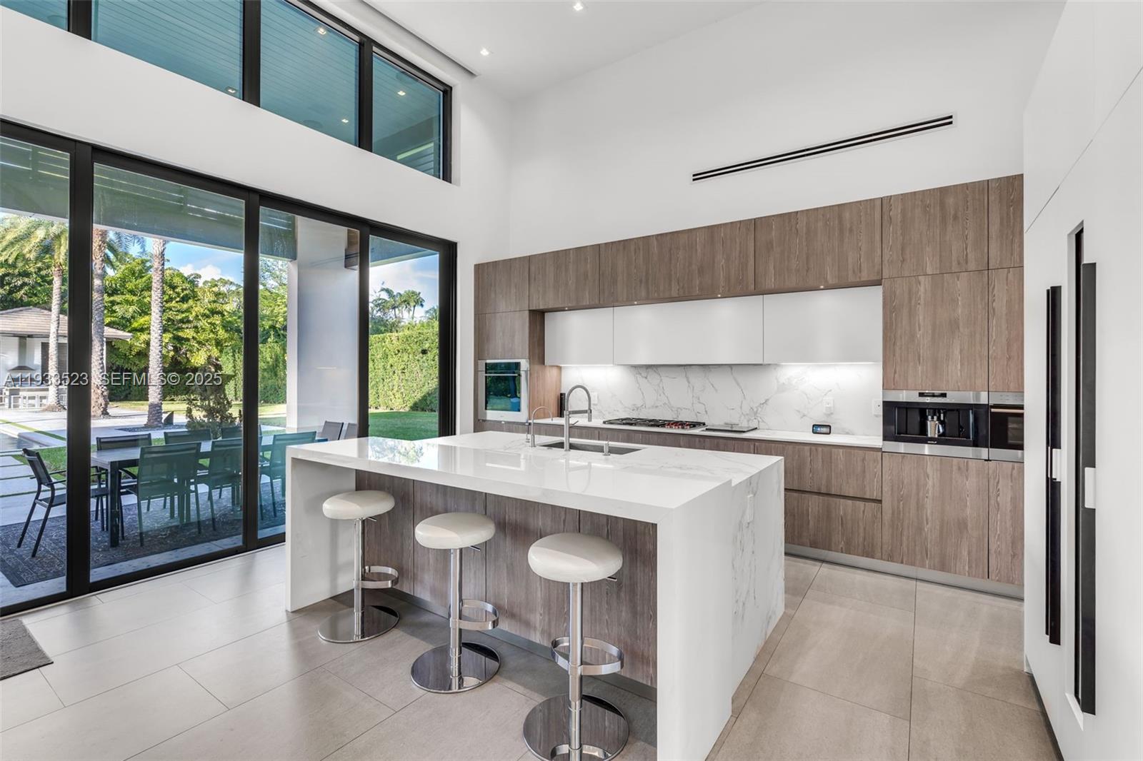 8271 Southwest 67th Street Miami, FL 33143 - Photo 34 of 88 a kitchen with a stove a refrigerator and a table