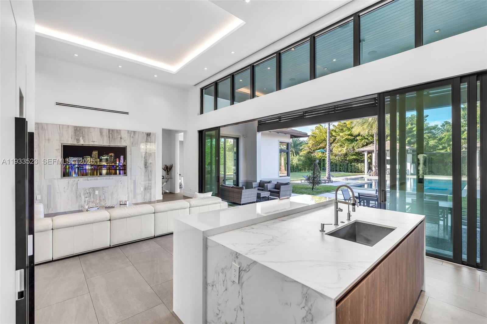 8271 Southwest 67th Street Miami, FL 33143 - Photo 36 of 88 a kitchen with a stove a sink and a refrigerator