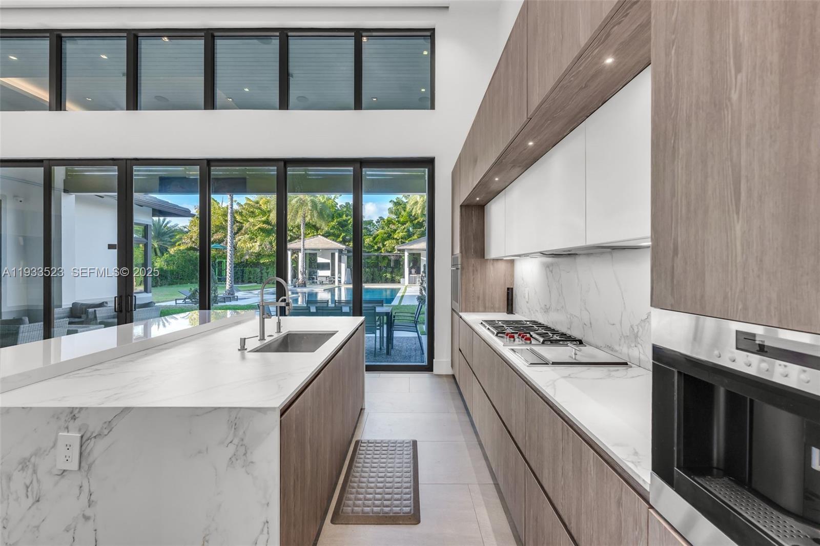 8271 Southwest 67th Street Miami, FL 33143 - Photo 38 of 88 a kitchen with stainless steel appliances granite countertop a stove and a sink