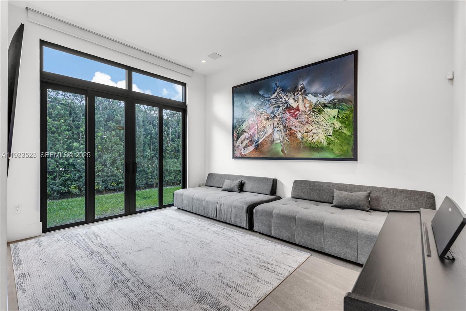 8271 Southwest 67th Street Miami, FL 33143 - Photo 43 of 88 a living room with furniture large window and a flat screen tv