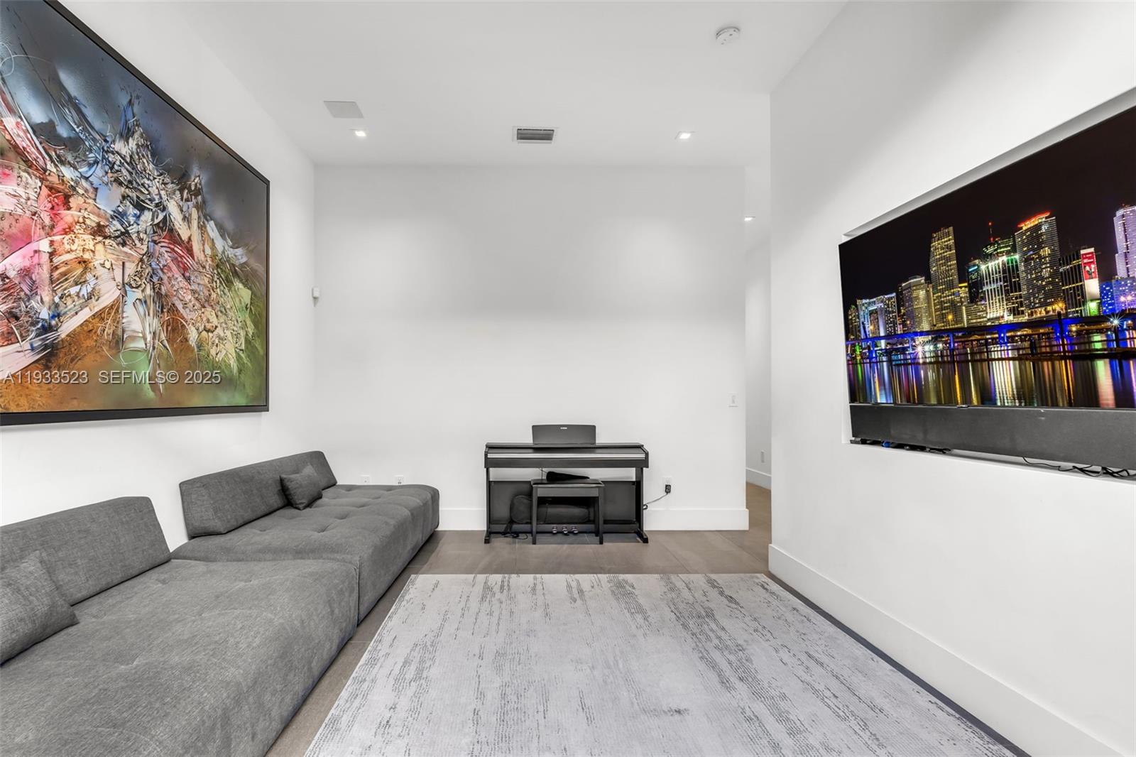 8271 Southwest 67th Street Miami, FL 33143 - Photo 44 of 88 a living room with furniture and a flat screen tv