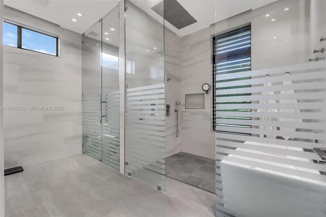 an aerial view of residential houses with outdoor space and trees