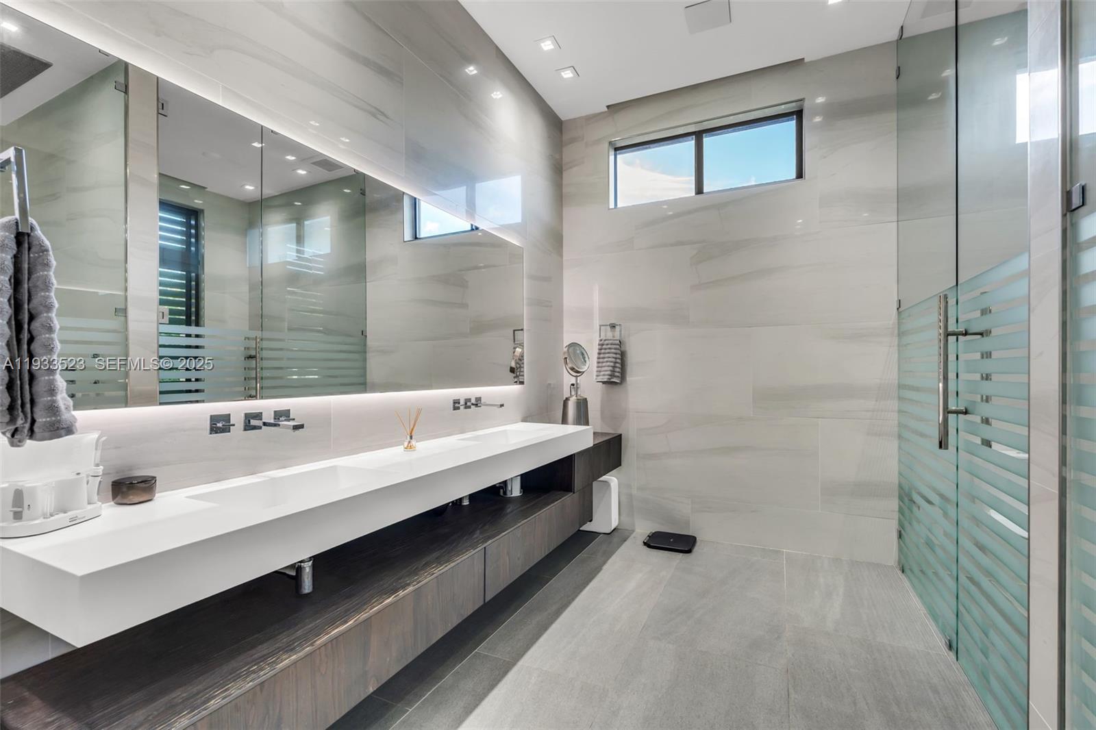 8271 Southwest 67th Street Miami, FL 33143 - Photo 55 of 88 a bathroom with a double vanity sink mirror and shower