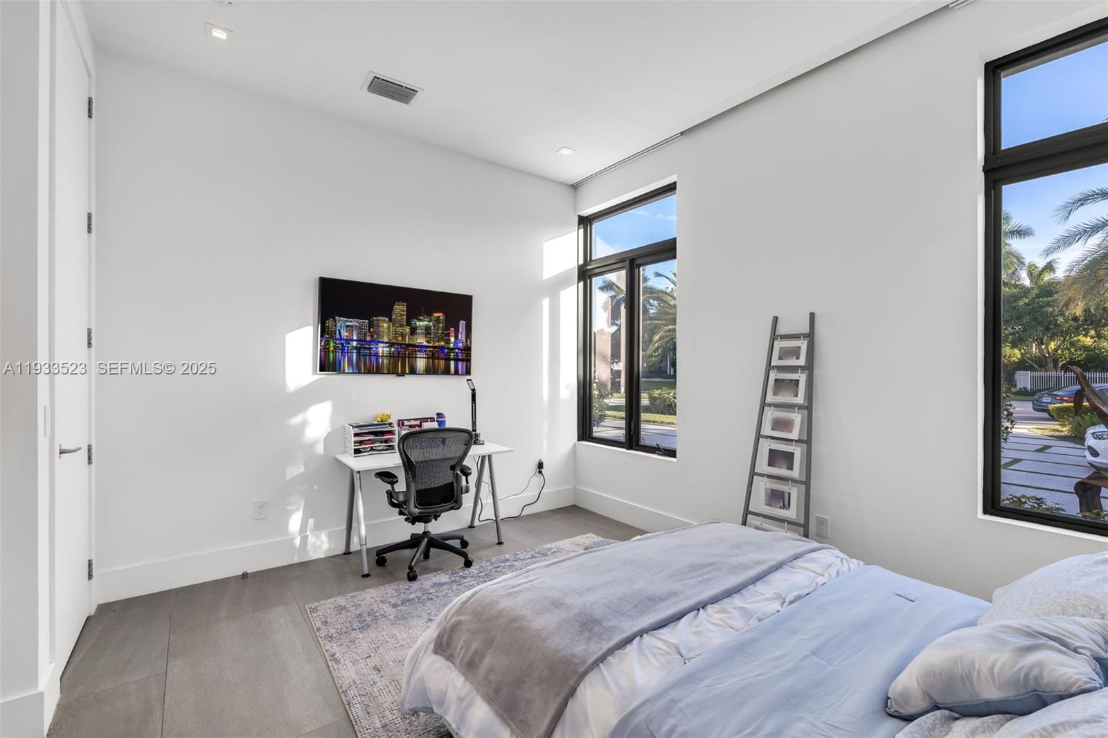 8271 Southwest 67th Street Miami, FL 33143 - Photo 62 of 88 a bedroom with a bed and a window